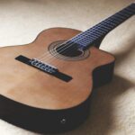 Detailed shot of a classical acoustic guitar highlighting strings and craftsmanship.
