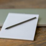 black pen on white notebook